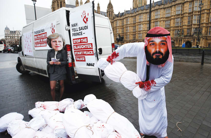 ACTIVISTS STAGE a protest timed to coincide with the visit by Saudi Crown Prince Mohammad bin Salman, also mocking British Prime Minister Theresa May, outside Parliament in London on March 7. (photo credit: REUTERS)