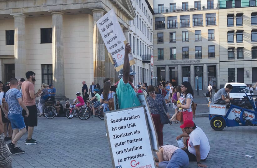 ‘THE FINAL outrage came from the man at the Brandenburg Gate who held a sign comparing Israelis to the Nazis and alleging a world Zionist conspiracy.’ (photo credit: MICAH THAU)
