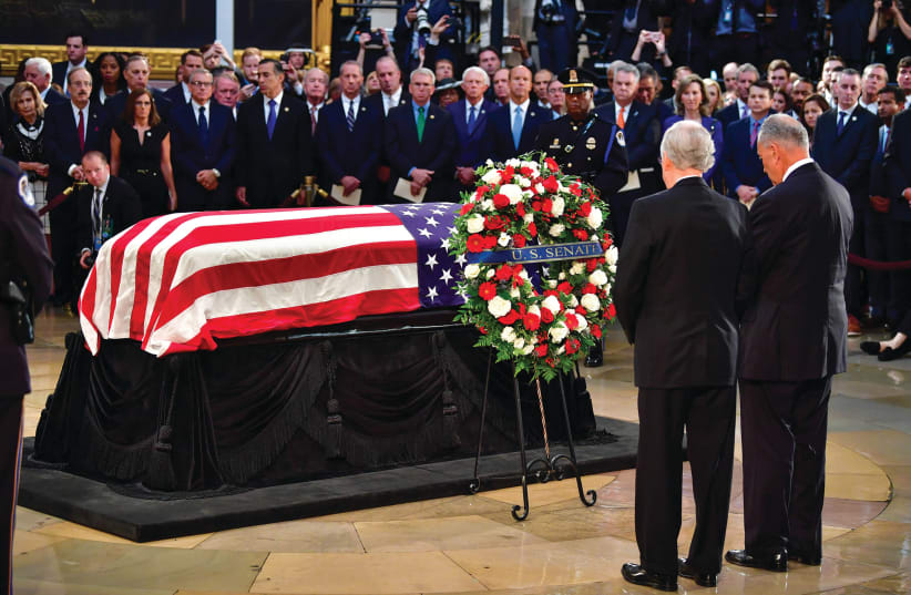 JOHN MCCAIN’S casket rests in front of mourners (photo credit: REUTERS)