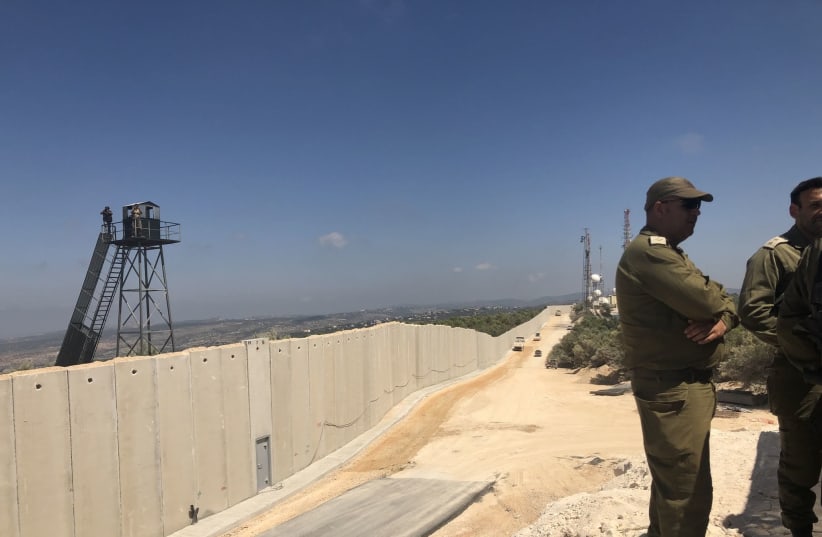 IDF officers stand near Israel's newly built wall on the Lebanon border (photo credit: ANNA AHRONHEIM)