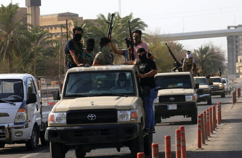 VEHICLES OF Iraq’s Popular Mobilization Forces patrol the streets of Basra last week.  (photo credit: REUTERS)