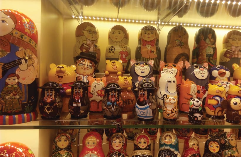 A store in Moscow’s Arbat pedestrian mall displays traditional Russian babushka dolls, including some on Jewish themes.  (photo credit: LIAT COLLINS)