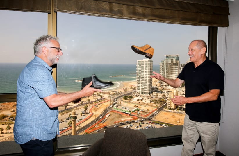 TEVA NAOT owner Steve Lax (right) and Teva manager Michael Illouz ‘play catch’ with Naot shoes in Tel Aviv (photo credit: MARC ISRAEL SELLEM/THE JERUSALEM POST)