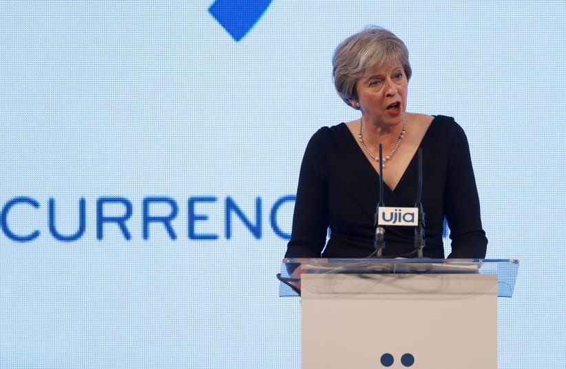 Britain's Prime Minister Theresa May speaks at the United Jewish Israel Appeal charity dinner in London (photo credit: PETER NICHOLLS/REUTERS)