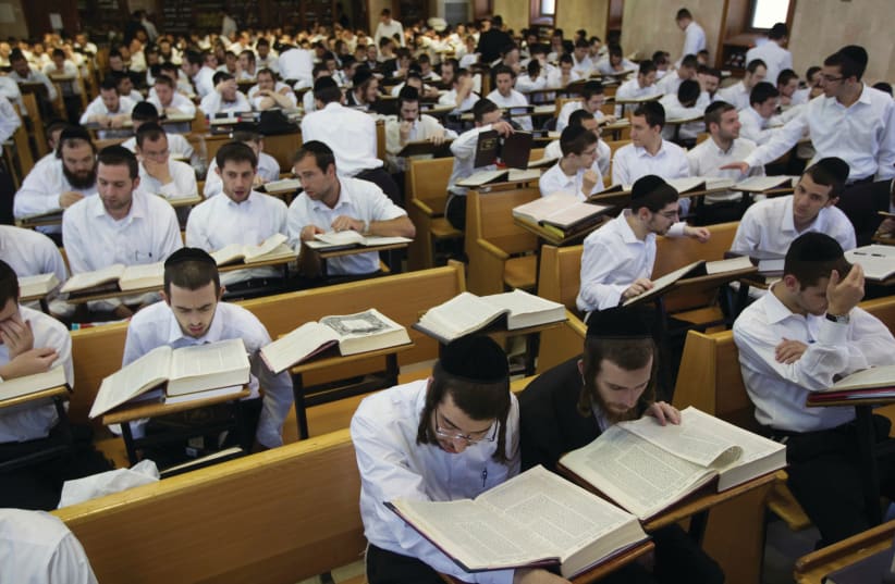 Jewish men study in a yeshiva. (photo credit: RONEN ZVULUN/REUTERS)
