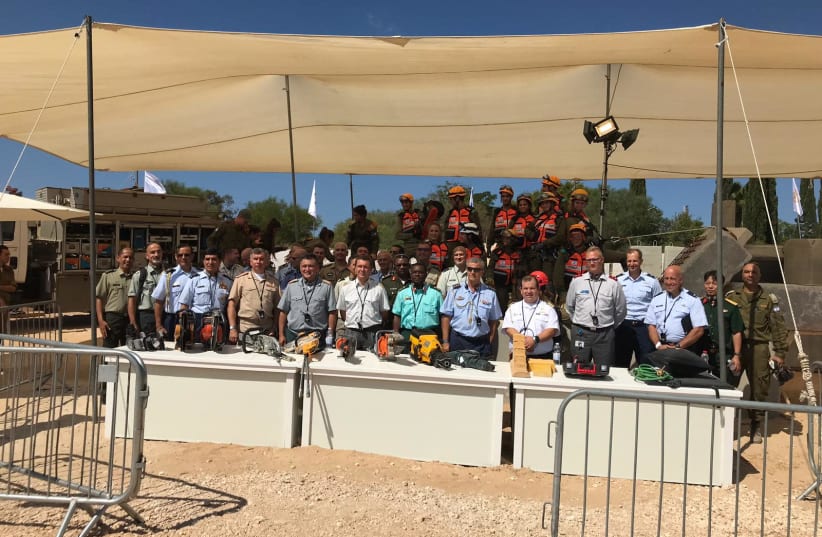 Defense attaches pose next to IDF search and rescue at "Our IDF" exposition in Holon, September 20, 2019 (photo credit: SETH J. FRANTZMAN)
