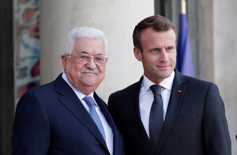 French President Emmanuel Macron welcomes Palestinian President Mahmoud Abbas as he arrives for a meeting at the Elysee Palace in Paris, France, September 21, 2018.  (photo credit: BENOIT TESSIER /REUTERS)