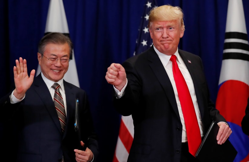 US President Donald Trump and South Korean President Moon Jae-in gesture after signing the US-Korea Free Trade Agreementon during a ceremony on the sidelines of the 73rd United Nations General Assembly in New York, September 24, 2018 (photo credit: CARLOS BARRIA / REUTERS)