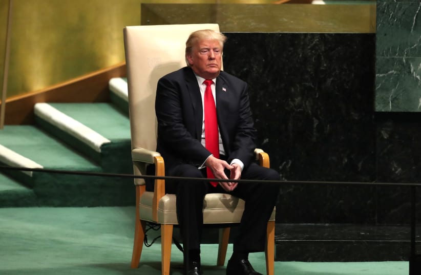US President Donald Trump sits in the chair reserved for heads of state before delivering his address during the 73rd session of the United Nations General Assembly at UN headquarters in New York, September 25, 2018 (photo credit: CARLO ALLEGRI/REUTERS)