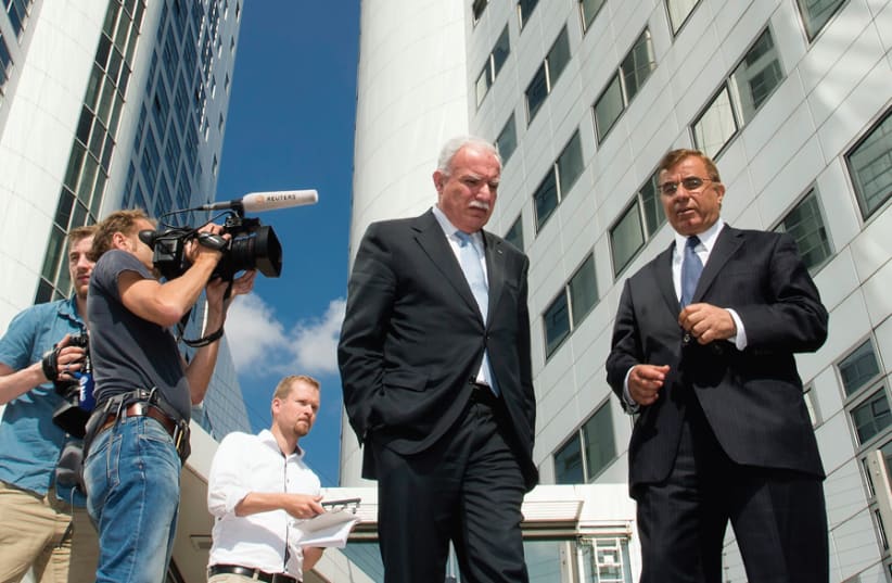PALESTINIAN FOREIGN MINISTER Riad al-Malki (center) leaves the International Criminal Court at the Hague on August 5, 2014, saying there was ‘clear evidence’ Israel had committed war crimes in Gaza. (photo credit: Courtesy)