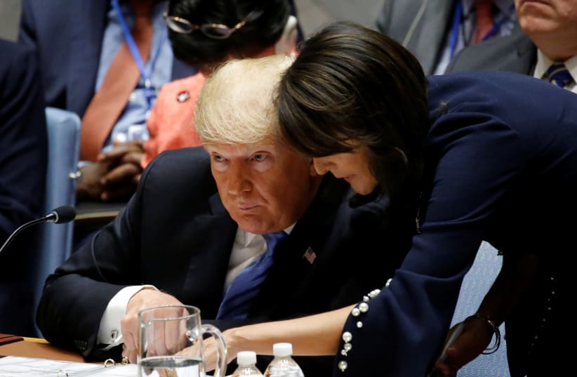  US President Donald Trump and US Ambassador to the United Nations Nikki Haley confer during a meeting of the United Nations Security Council held during the 73rd session of the United Nations General Assembly at UN headquarters in New York, US, September 26, 2018 (photo credit: EDUARDO MUNOZ / REUTERS)