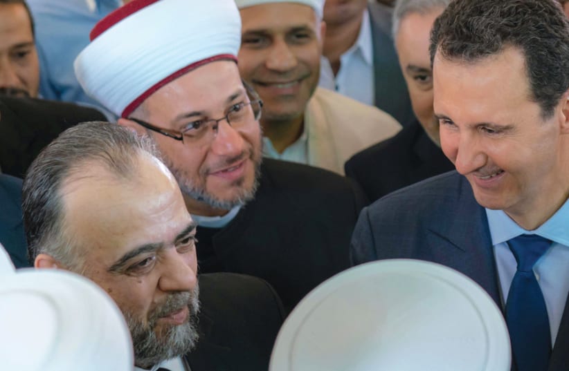 SYRIAN PRESIDENT Bashar Assad greets supporters during Eid al-Adha prayers at a Damascus mosque on August 21. (photo credit: REUTERS)