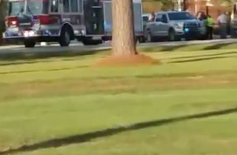 Emergency personnel are seen on site in the aftermath of a shooting in Florence, South Carolina, U.S. October 3, 2018, in this still image obtained from a social media video. (photo credit: DEREK LOWE/REUTERS)