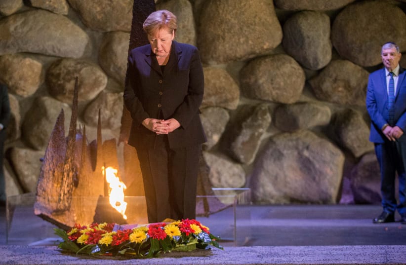 Angela Merkel lights the Eternal Flame and places a wreath at Yad Vashem, 2018. (photo credit: OREN BEN HAKON)