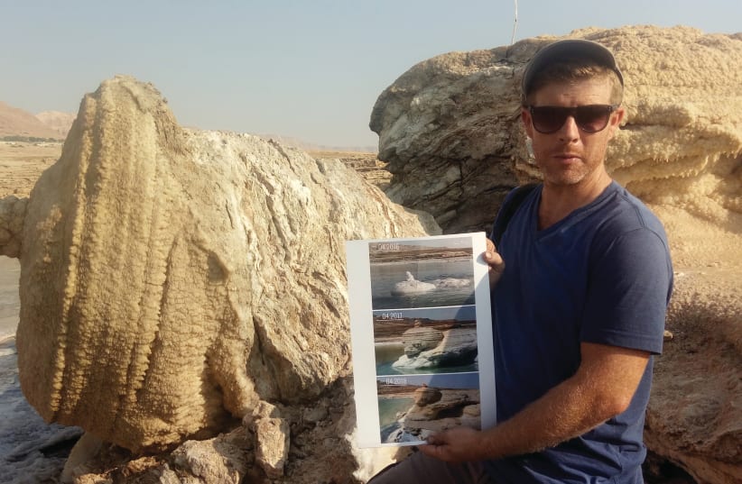 NOAM BEDEIN holds time-lapse images of the emergence of the magnificent salt structure that collapsed last month (photo credit: LIAT COLLINS)
