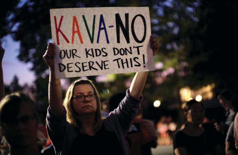 A WOMAN protests against Brett Kavanaugh (photo credit: REUTERS)
