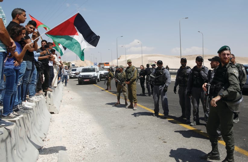 PALESTINIANS PROTESTING at Khan Al-Ahmar (photo credit: REUTERS)