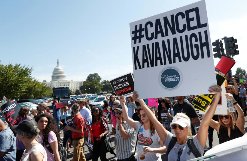 Activists hold a protest march and rally in opposition to U.S. Supreme Court nominee Brett Kavanaugh near the U.S. Capitol in Washington, US, October 4, 2018 (photo credit: KEVIN LAMARQUE/REUTERS)