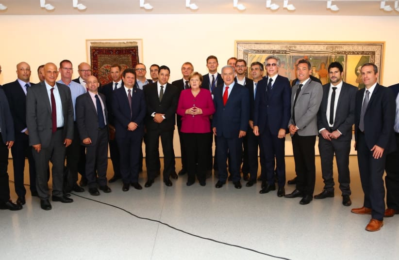 The 'embarrassing' photo of German Chancellor Angela Merkel at an all-male event which inspired Israeli feminists (photo credit: KOBI GIDON / GPO)