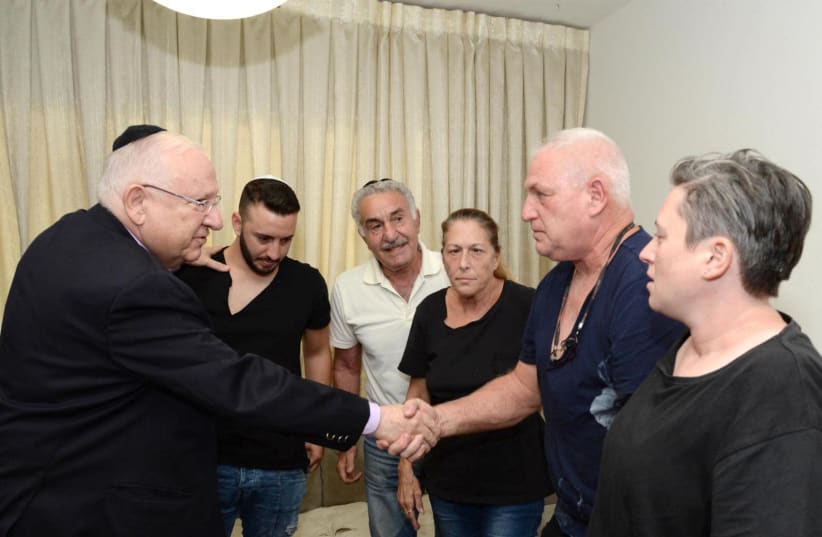 Israeli President Reuven Rivlin visited the families of the victims of the terror attack at Barkan Industrial Facility (photo credit: MARK NEYMAN/GPO)
