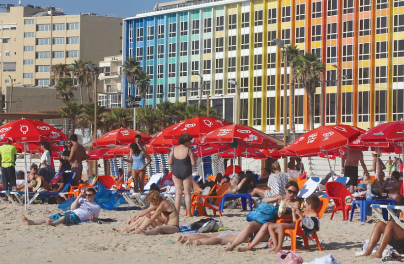 Israelis enjoy the sunshine on a Tel Aviv beach (photo credit: MARC ISRAEL SELLEM)