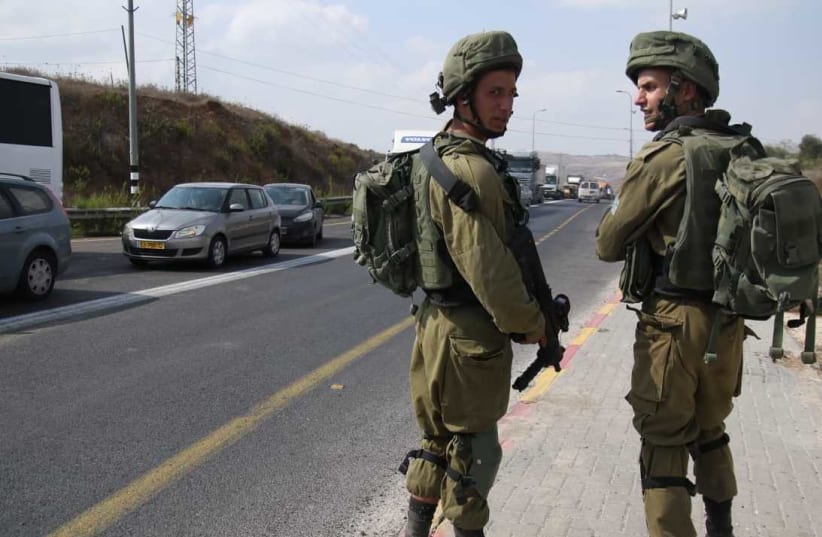 Soldiers at the scene of a stabbing attack in the West Bank on October 11, 2018. (photo credit: TAZPIT)