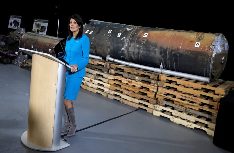 US Ambassador to the UN Nikki Haley briefs the media in front of remains of an Iranian ‘Qiam’ ballistic missile at Joint Base Anacostia-Bolling in Washington in December 2017. (photo credit: REUTERS/YURI GRIPAS)