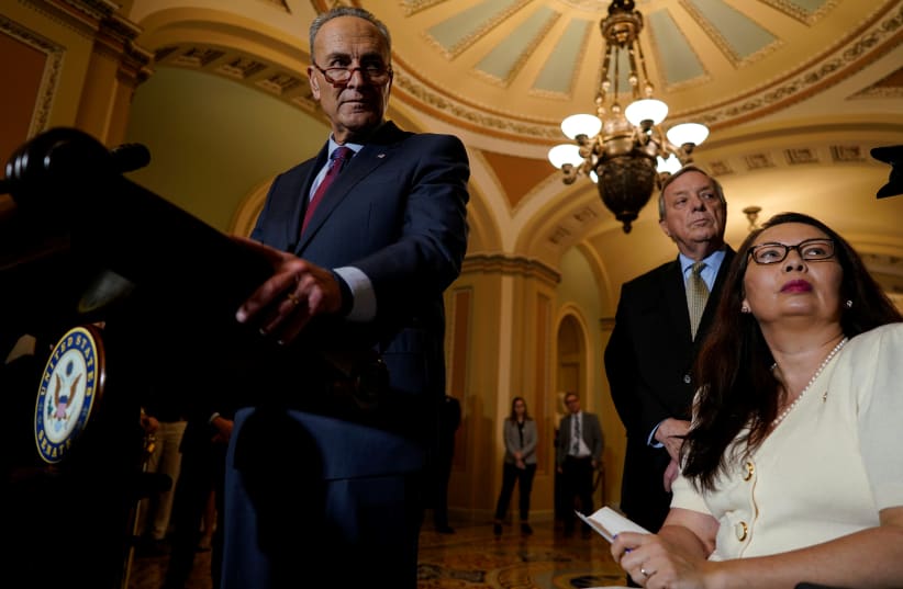 Senate Minority Leader Chuck Schumer, accompanied by Sen. Dick Durbin (D-IL) and Sen. Tammy Duckworth (D-IL), speaks with reporters following the weekly policy luncheons on Capitol Hill in Washington, October 2, 2018 (photo credit: AARON P. BERNSTEIN/ REUTERS)