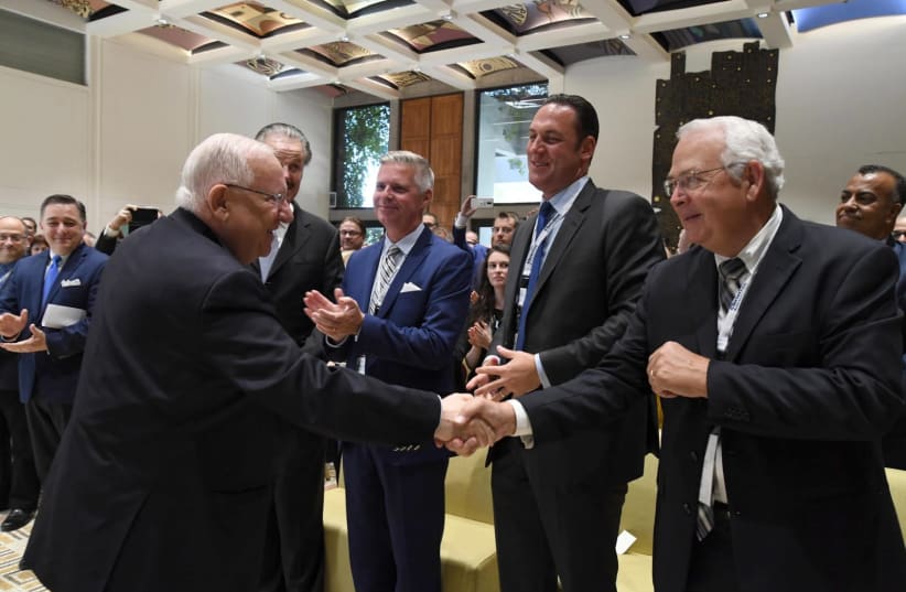 President Reuven Rivlin (L) at the Christian Media Summit, October 16, 2018 (photo credit: MARK NEYMAN/GPO)