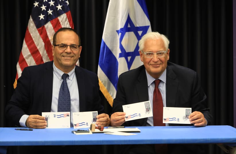 COMMUNICATIONS MINISTER Ayoub Kara (left) and US Ambassador David Friedman display first day covers of new joint Israel-US postage stamp for Hanukka (photo credit: SASSON TIRAM)