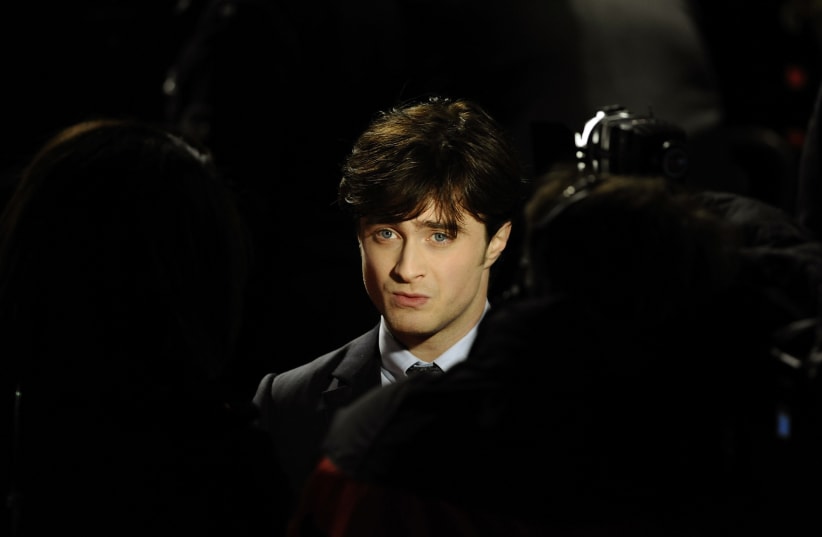 Britain's Daniel Radcliffe poses as he arrives for the world premiere of "Harry Potter and the Deathly Hallows: Part 1" at Leicester Square in London November 11, 2010.  (photo credit: DYLAN MARTINEZ/REUTERS)