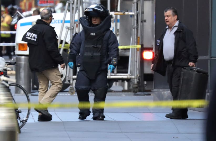 A member of the New York Police Department bomb squad is pictured outside the Time Warner Center in the Manhattan borough of New York City after a suspicious package was found inside the CNN Headquarters in New York, US, October 24, 2018 (photo credit: REUTERS/KEVIN COOMBS)