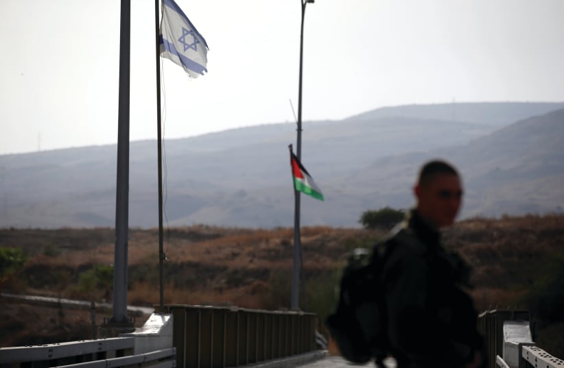 AN IDF soldier patrols the border area between Israel and Jordan at Naharayim, as seen from the Israeli side on October 22. (photo credit: RONEN ZVULUN/REUTERS)