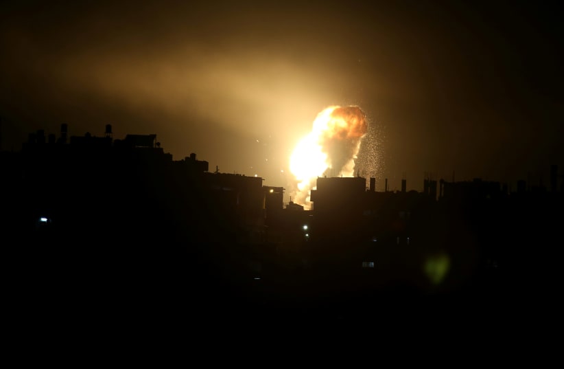 An explosion is seen during Israeli air strikes in the southern Gaza Strip October 27, 2018. (photo credit: IBRAHEEM ABU MUSTAFA / REUTERS)