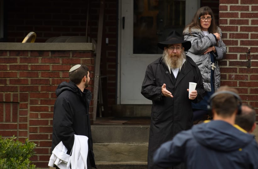 Residents talk to the media near the site of a mass shooting at the Tree of Life Synagogue in the Squirrel Hill neighborhood on October 27, 2018 in Pittsburgh, Pennsylvania (photo credit: JEFF SWENSEN / GETTY IMAGES NORTH AMERICA / AFP)