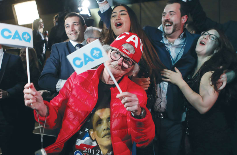 OALITION AVENIR DU QUEBEC party members celebrate in Quebec City on October 1 (photo credit: REUTERS/CHRIS WATTIE)