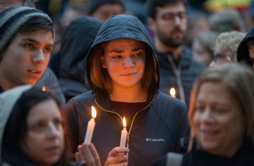 People hold a vigil for the victims of Pittsburgh synagogue shooting in Pittsburgh Pennsylvania (photo credit: REUTERS/JOHN ALTDORFER)