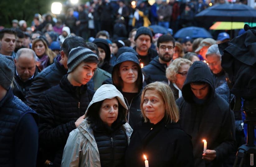 People mourn the loss of life as they hold a vigil for the victims of Pittsburgh synagogue shooting in Pittsburgh, Pennsylvania, October 27, 2018 (photo credit: JOHN ALTDORFER/REUTERS)
