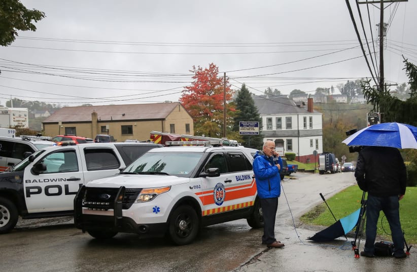 Police vehicles block off the road near the home of Pittsburgh synagogue shooting suspect Robert Bowers' home in Baldwin Baldwin borough, suburb of Pittsburgh, Pennsylvania, October 27, 2018 (photo credit: JOHN ALTDORFER/REUTERS)