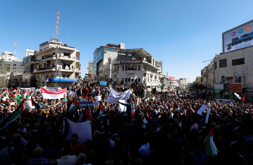 Palestinians take part in a protest against a social security law in Ramallah, October 29, 2018 (photo credit: MOHAMAD TOROKMAN/REUTERS)