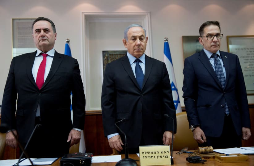 Israeli Prime Minister Benjamin Netanyahu (C), Transportation and Intelligence Minister Yisrael Katz (L), and Cabinet Secretary Tzachi Braverman stand for a moment of silence to honour the victims of a synagogue shooting in Pittsburgh, during the weekly cabinet meeting in Jerusalem October 28, 2018 (photo credit: ODED BALILTY/POOL VIA REUTERS)