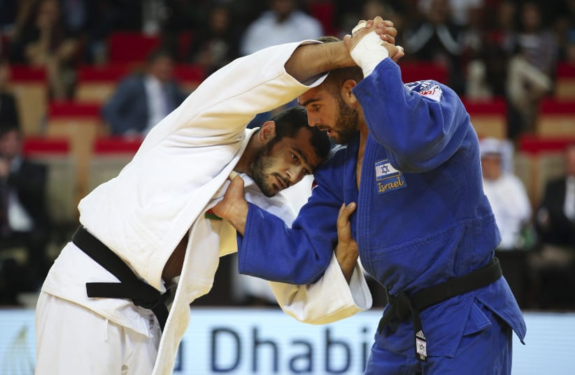 Peter Paltchik from Israel (blue) fights with against Gasimov Elmar (white) from Azerbaijan in the final of the under 100 kg weight category during the Judo Grand Slam 2018 in Abu Dhabi, on October 29, 2018 (photo credit: MAHMOUD KHALED / AFP)