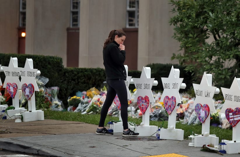 A woman reacts at a makeshift memorial outside the Tree of Life synagogue following Saturday's shooting at the synagogue in Pittsburgh, Pennsylvania, U.S., October 29, 2018 (photo credit: CATHAL MCNAUGHTON/REUTERS)