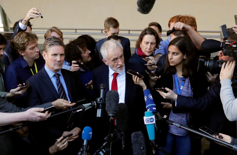 British Labour party opposition leader Jeremy Corbyn talks to reporters after a meeting with European Union's chief Brexit negotiator Michel Barnier at the EC headquarters in Brussels, Belgium September 27, 2018 (photo credit: YVES HERMAN / REUTERS)