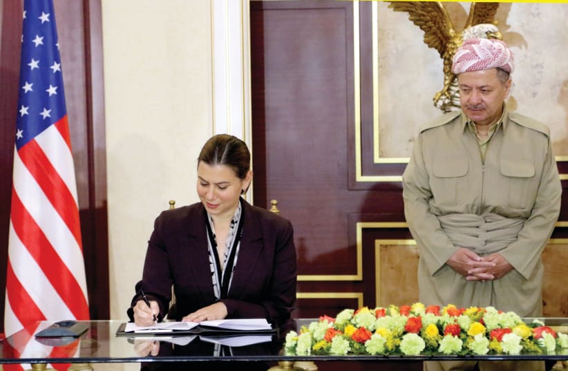 Elissa Slotkin, now a Democratic candidate in Michigan, signs an agreement to support the Kurdistan Region's during the war against the ISlamic State when she was an Assistant Secretary of Defense for International Security Affairs in 2016 (photo credit: REUTERS)