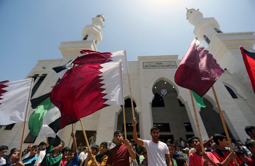 Palestinians take part in a rally in support of Qatar, inside Qatari-funded construction project 'Hamad City', in the southern Gaza Strip, June 9, 2017 (photo credit: REUTERS/IBRAHEEM ABU MUSTAFA)