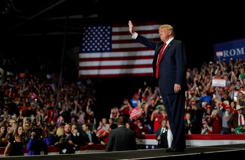 U.S. President Donald Trump waves to supporters at a campaign rally on the eve of the U.S. mid-term elections at the Show Me Center in Cape Girardeau, Missouri, U.S., November 5, 2018. (photo credit: CARLOS BARRIA / REUTERS)
