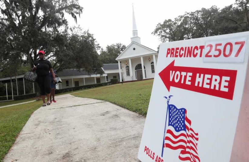 Voters leave a polling station in Tallahassee, Florida, November 6, 2018 (photo credit: SHANNON STAPLETON/ REUTERS)