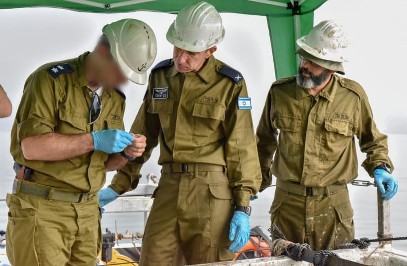 Offices from the Israeli Air Force review the remains of Yakir Naveh's plane.  (photo credit: IAF)