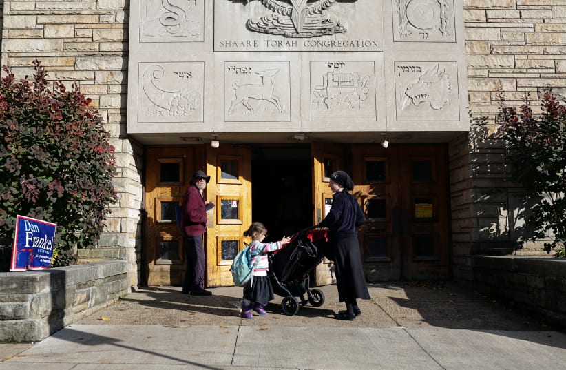 A Jewish Orthodox woman and her daughter wait to vote during mid-term elections at a polling station in Pittsburgh, Pennsylvania, U.S. November 6, 2018 (photo credit: FEDERICA VALABREGA)